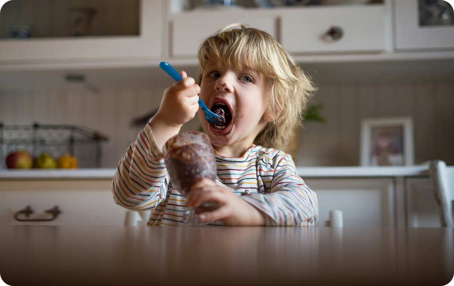 Kid eating with a spoon