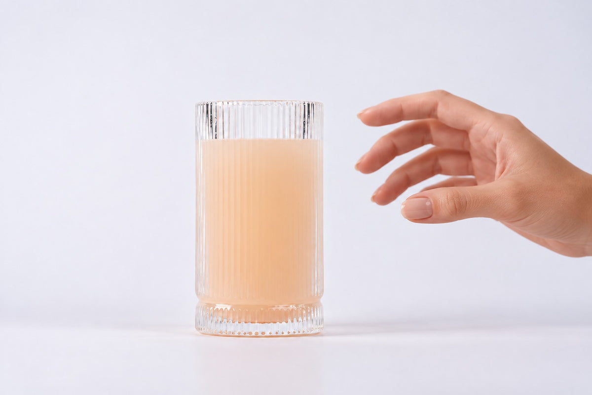 Hand reaching for a glass of mixed Anomaly